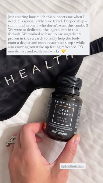 A close-up shot of a deep sleep supplement bottle held in hand, resting over a luxury eye mask to establish a calming nightly routine.